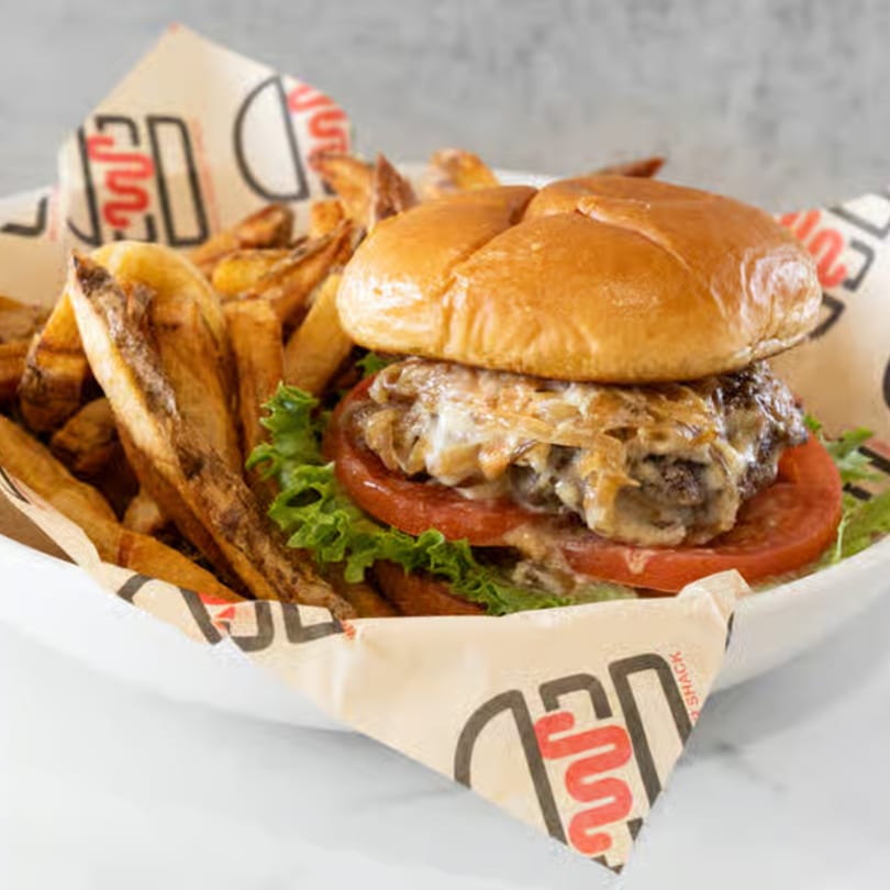 Wagyu Burger Shack burger with melted cheese, lettuce, tomato, and a side of fries.